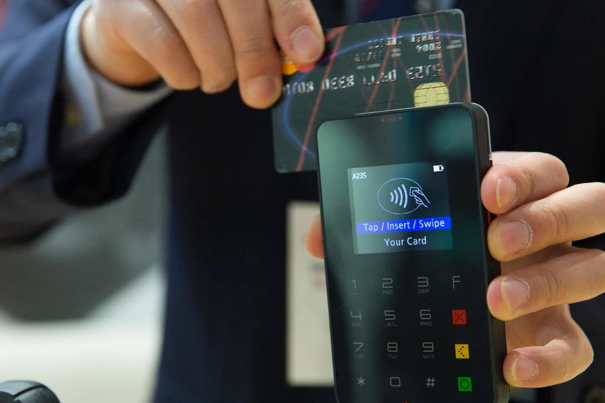 Man swiping credit card with a mobile card reader.