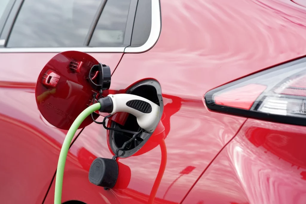 Electric vehicle being charged at EV charging station.